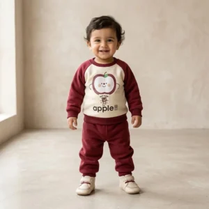 Cute two-piece tracksuit set featuring a maroon and cream sweatshirt with matching pants. Adorned with an adorable apple character print and a charming front patch detail. Crafted from soft, cozy fabric designed to keep your toddler warm and comfortable. Elasticated waistband and ribbed cuffs ensure a gentle, secure fit for active play. Perfect choice for daily casual wear, indoor lounging, and cool weather outings.